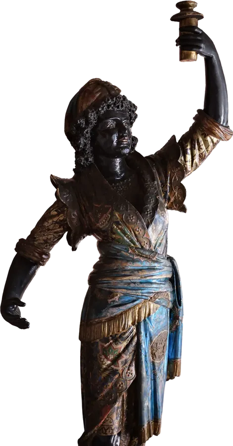 A carved statue holding a torch.